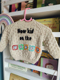 Hand embroidered New Kids on the Block design. Beige hand knitted jumper 6-12 months