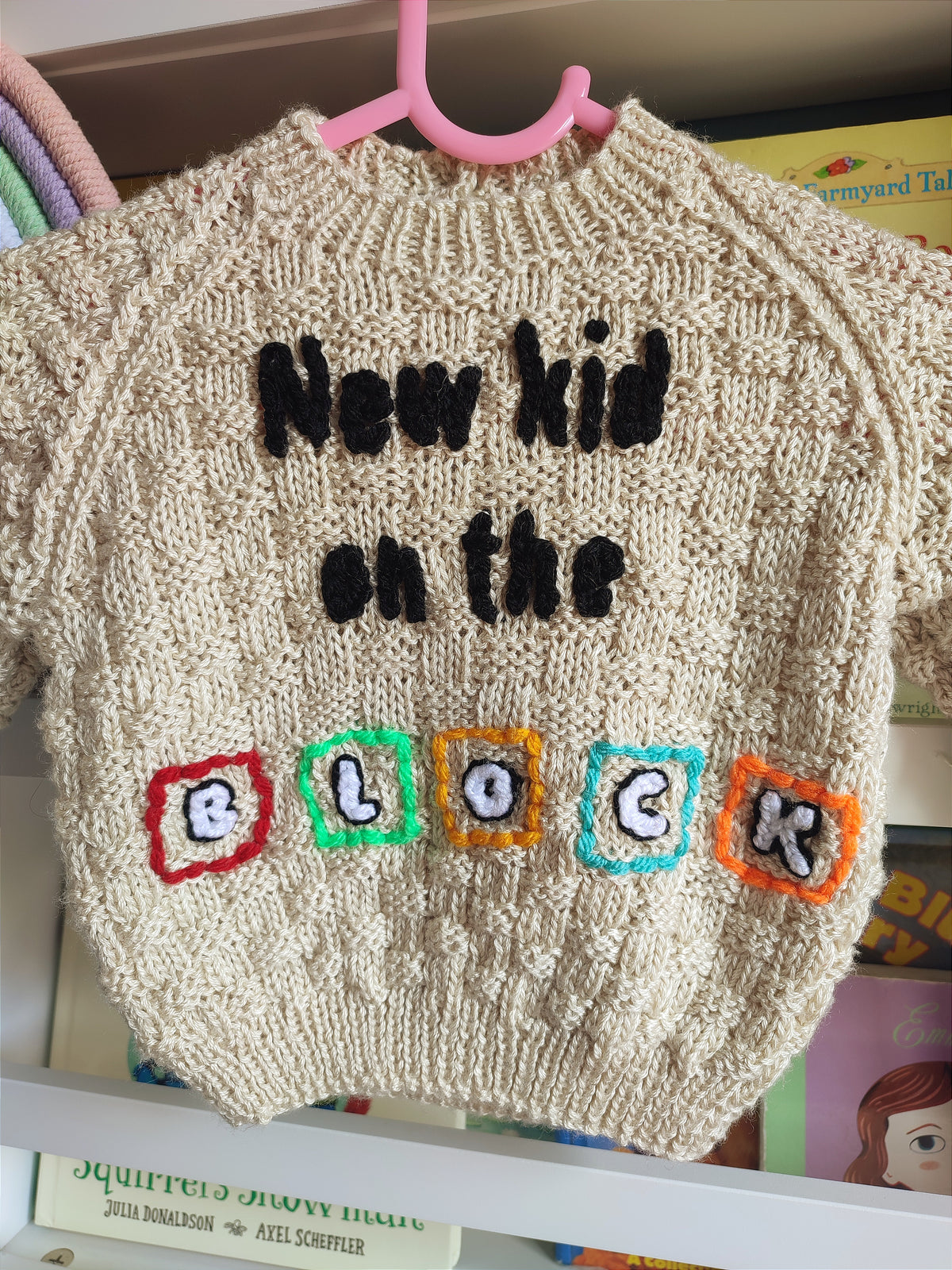 Hand embroidered New Kids on the Block design. Beige hand knitted jumper 6-12 months